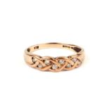 A 9ct gold Celtic knot design ring set with white stones, approx UK size 'N', 1.7g.