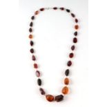 A yellow metal wire mounted Baltic amber graduated bead necklace .