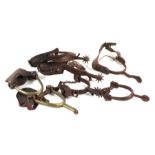 A group of spurs to include a pair of WWI 1916 Skinner spurs and a pair of Crockett Western Cowboy