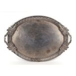 A large 19th century Indian white metal two handled tray with foliate decoration..59cm wide.