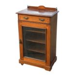 A l;ate 19th century inlaid mahogany music cabinet with single frieze drawer above a glazed door