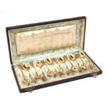 A cased set of twelve German 800 grade ornate silver gilt spoons by Wilhelm Rentrop of Altena,