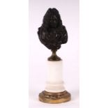 A bronze bust depicting Louis XIV on a marble column, 22cms high.