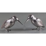 A pair of modern silver models of kingfishers, modelled in a standing position with textured feather