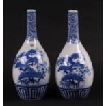 A pair of Japanese Arita blue & white bottle vases, 25cms high (2).