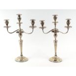 A pair of Adam style silver plated candelabra with spiral tapering columns terminating in urn