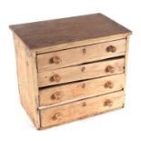 A miniature pine chest with four graduated long drawers, 37cms wide.