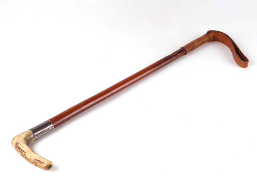 A mid 20th century Cartier Ltd antler handled Malacca riding crop with silver collar, Jean-Jacques