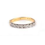 An 18ct gold ring set with nine diamonds, approx UK size 'P', 3g.Condition ReportShank ok, not thin