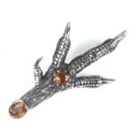 A Victorian white metal Scottish claw brooch set with two citrine coloured stones with date