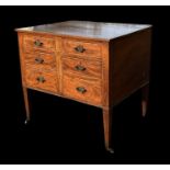 An Edwardian mahogany inlaid chest with two banks of graduated short drawers, on square tapering