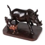 A carved hardwood group depicting a wart hog and hog, on a bases, 26cms wide.