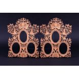 A pair of Chinese carved wood triple portrait miniature frames with bird and foliage decoration,