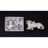 A Chinese jade or hardstone miniature panel depicting birds in foliage, 7cms wide; together with a