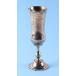 A Russian silver Kiddush cup with scrolling decoration and knopped stem, bears Russian hallmarks,