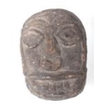 An early carved stone head, 13cms high.