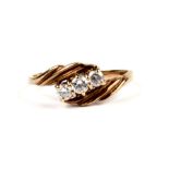A 9ct gold dress ring set with three white stones, approx UK size 'P', 1.8g.