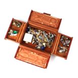 A quantity of costume jewellery in a faux crocodile skin leather jewellery box.