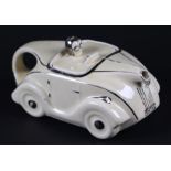 An Art Deco novelty teapot in the form of a car, registration no. 820236, 22cms long.Condition