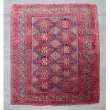 A fine quality Persian rug with two rows of geometric guls, on a red ground, 265 by 205cms (79/19).