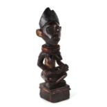 African / Tribal Art. A Congo yomba fertility figure in the form of a seated female figure