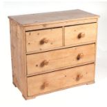 A pine chest of two short and two long drawers, on bracket feet, 86cms wide.