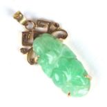 A Chinese yellow metal mounted jade pendant, 3cms high.