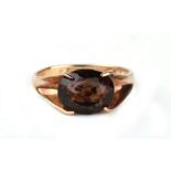 A 9ct gold and oval smokey quartz solitaire ring, approx UK size 'L', 2.7g.