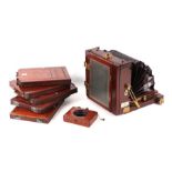 A Victorian mahogany folding plate camera with plate holders, shutter timer (Thornton Packard) and