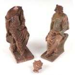 Two Hellenistic style pottery figures depicting robed seated women, the largest 18cms high (2).