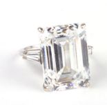 An 18ct white gold dress ring, the central emerald cut white stone being approx 16ct, approx UK size