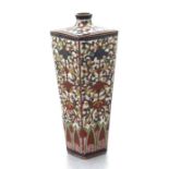 A late 19th century Japanese cloisonne vase of square tapering form, decorated with flowers, on a