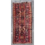 A Persian Azari hand knotted woollen runner with stylised animals and bird motifs on a beige ground,