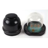 A table top four-dice shaker in ebonised case and under glass dome, 17cms high.