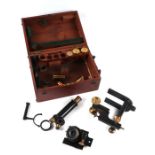 A black lacquer and brass microscope with a selection of lenses, cased.