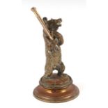 A novelty cast brass pen stand in the form of a grizzly bear on a plinth, 18cms high.