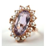 A 9ct gold dress ring set with a large oval amethyst surrounded by pearls, approx UK size 'K', 3.