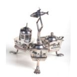 An Iraqi Marsh Arab silver three-piece cruet in stand with articulated fish finial, the niello