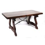 A Spanish style hardwood refectory table on lyre shaped supports, 160cms wide.