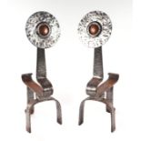 A pair of Arts & Crafts polished steel fire dogs with hammered decoration and inset copper