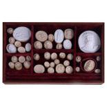 A collection of forty Grand Tour plaster intaglios, the largest 8.6cms, contained within a velvet