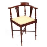 An Edwardian mahogany corner chair with boxwood stringing, on turned legs joined by an 'X'