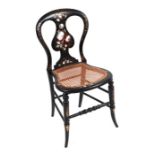 A Victorian ebonised gilt and mother and pearl inlaid side chair with shaped cane seat.