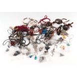 A quantity of vintage and modern costume jewellery to include necklaces and earrings.