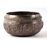 A Burmese silver coloured metal bowl with repousse decoration depicting dancing figures, 13cms
