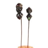 A pair of late 19th century Austro-Hungarian silver gem set stick pins with figural turbaned