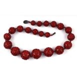 A fine Chinese carved cinnabar lacquer graduated ball necklace with silver clasp (clasp a/f).
