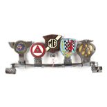 A chrome plated badge bar and five bar badges to include Institute of Advanced Motorists, MG Car