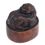 A fine Chinese carved wooden seal surmounted with a Kylin, four characters to the matrix, 5.5cms