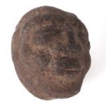 An early carved stone head, 14cms high.